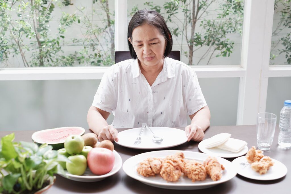 elderly woman unable to eat food